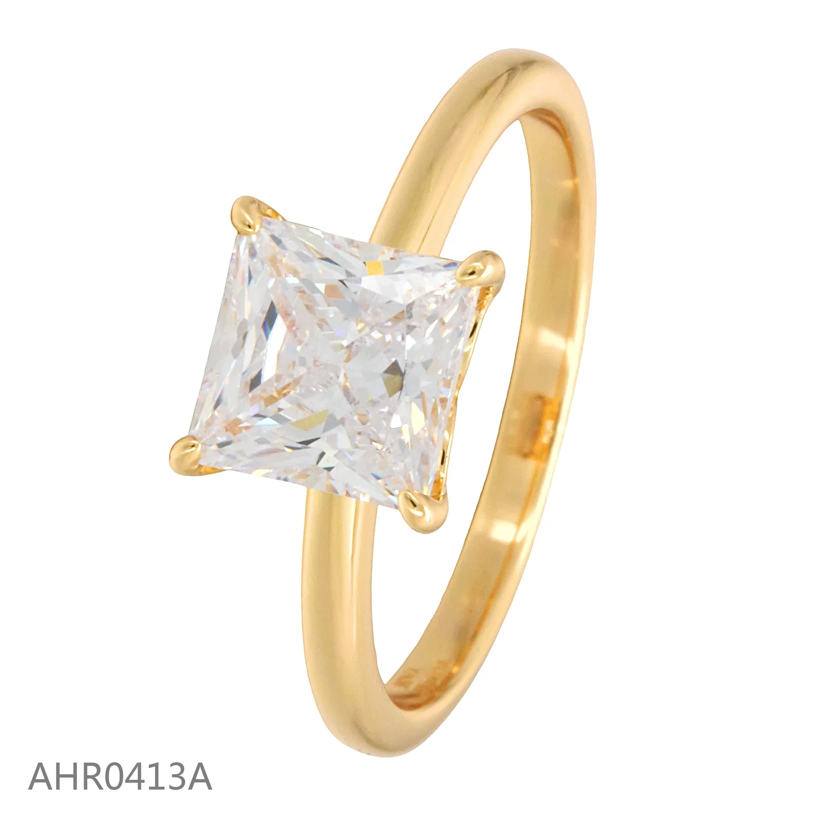 Gold-tone solitaire ring with a square clear stone and corner prongs