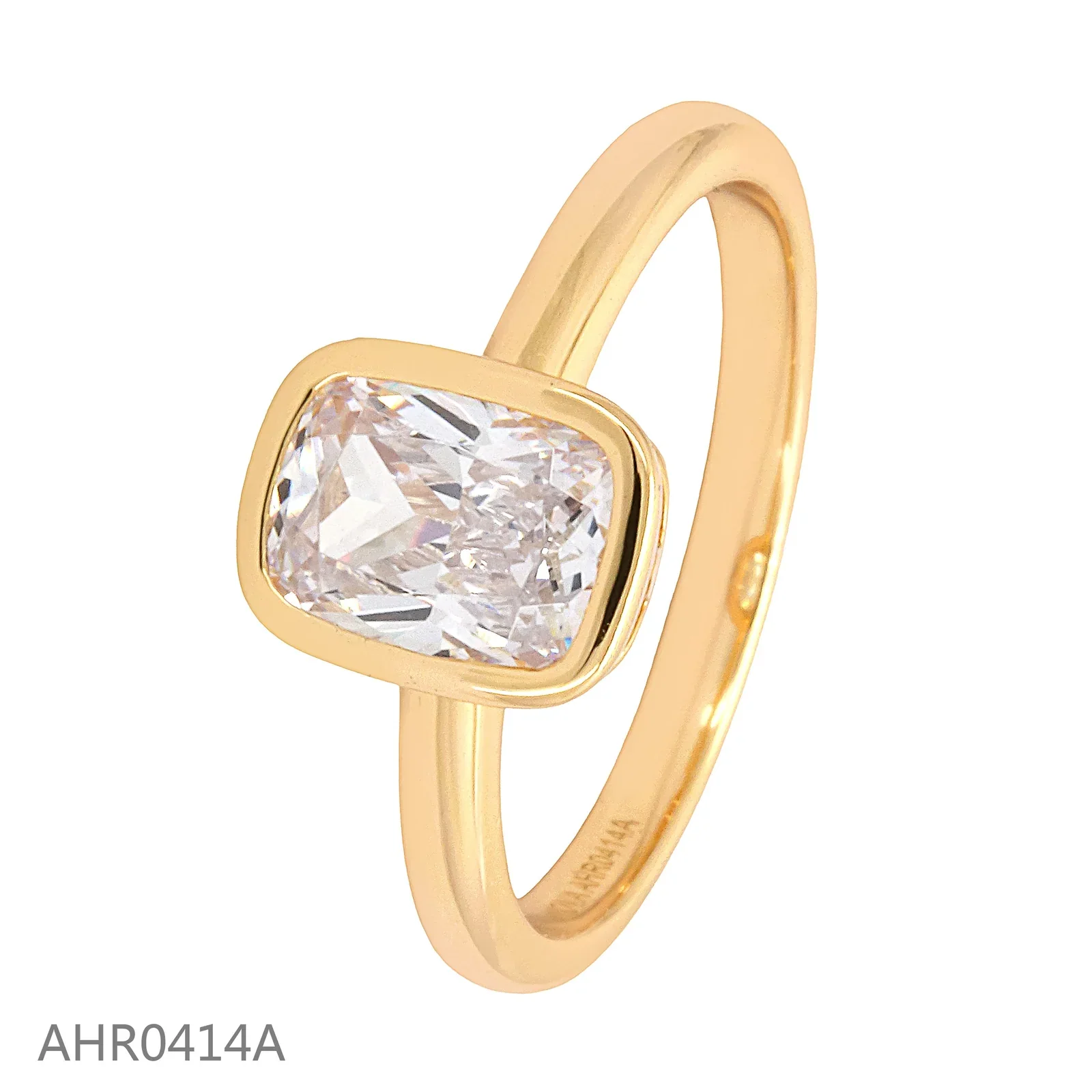 Gold-tone solitaire ring with a rectangular clear stone in a bezel setting