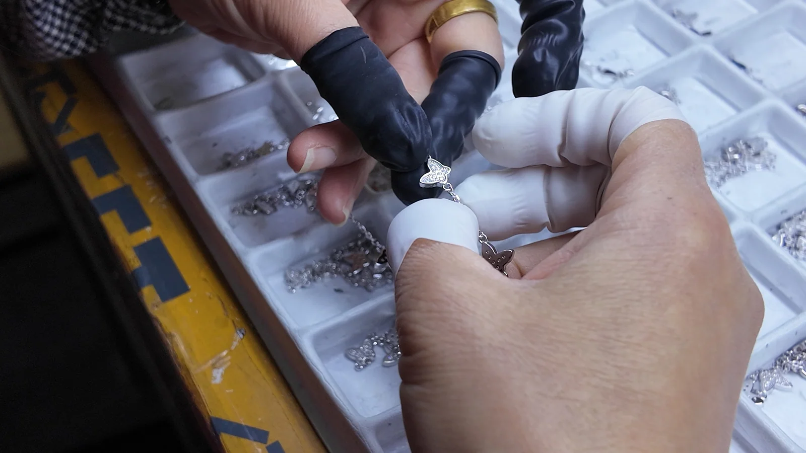 A jewelry component being reviewed during assembly