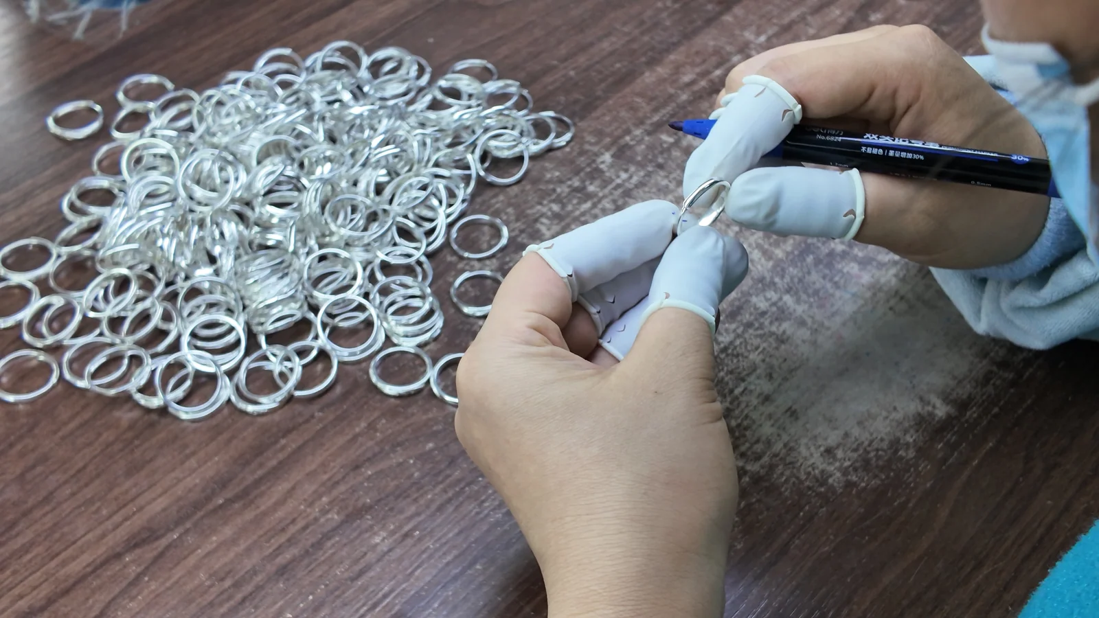 Silver jewelry components arranged for incoming batch review