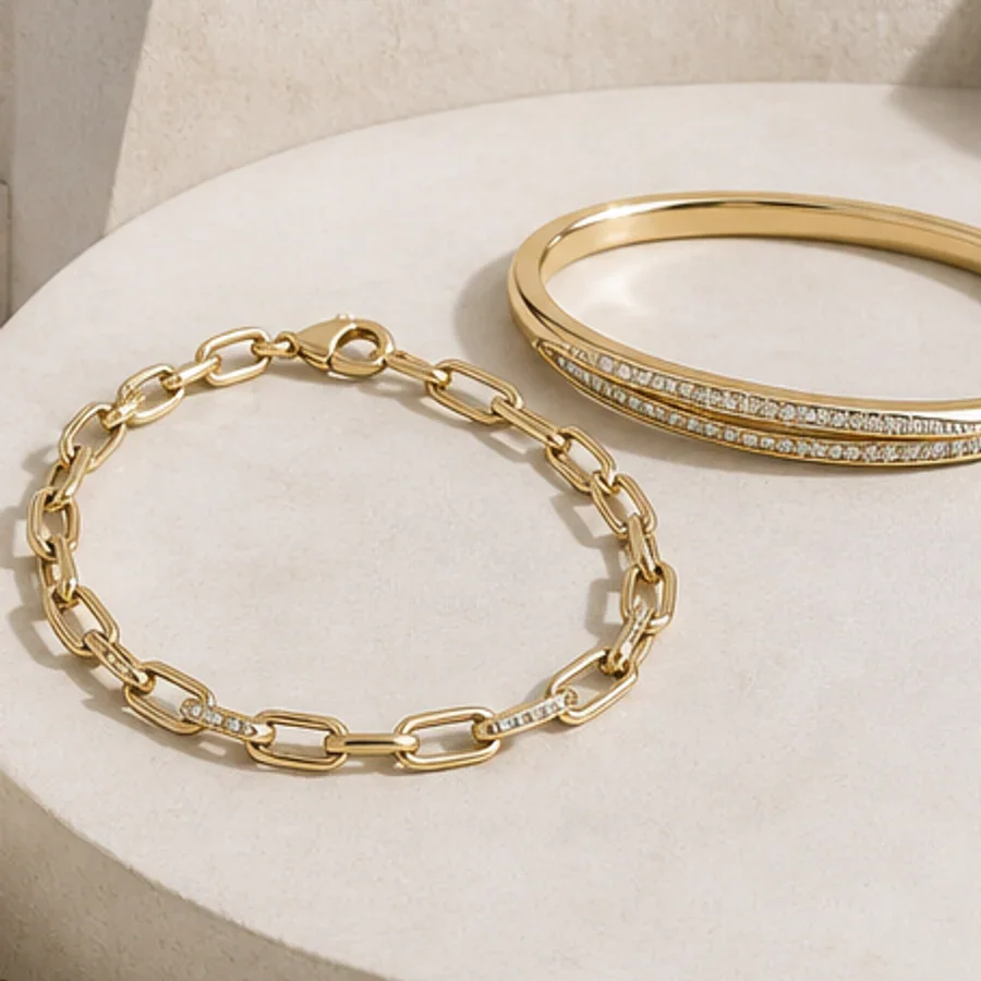 Illustrative gold-tone chain bracelet and stone-set bangle