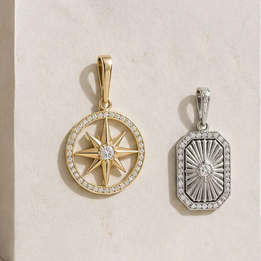 Illustrative gold-tone compass pendant and silver-tone sunburst pendant