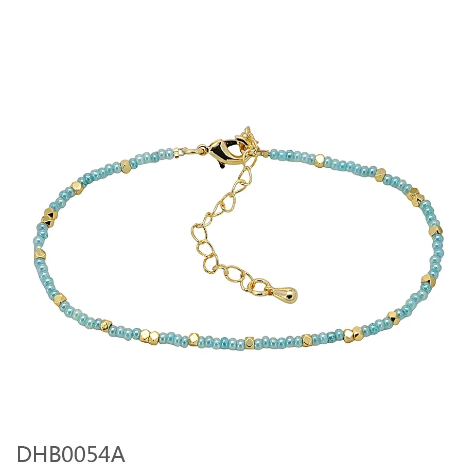 Turquoise beaded bracelet with gold-tone spacers and an adjustable chain