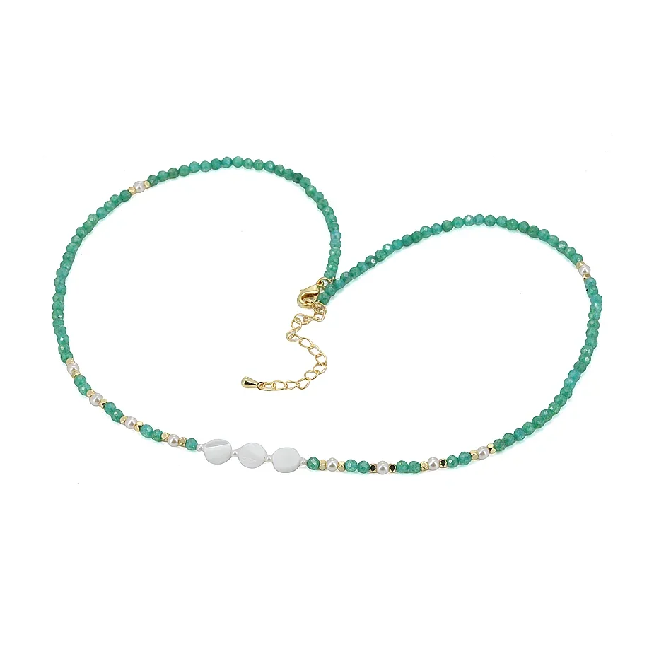 Green beaded necklace with three white center beads and gold-tone details