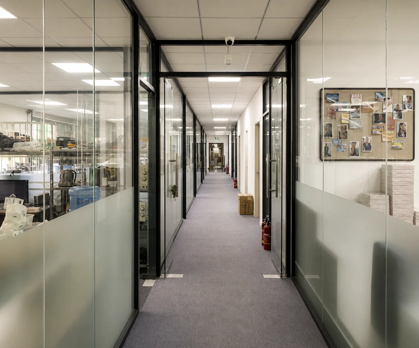 A glass-lined corridor connecting work areas inside the NOVA factory
