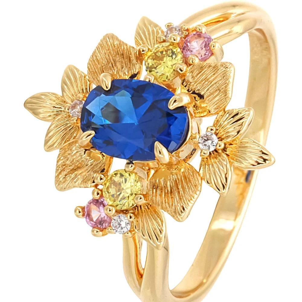 Gold-tone floral ring with an oval blue center stone and pink accents