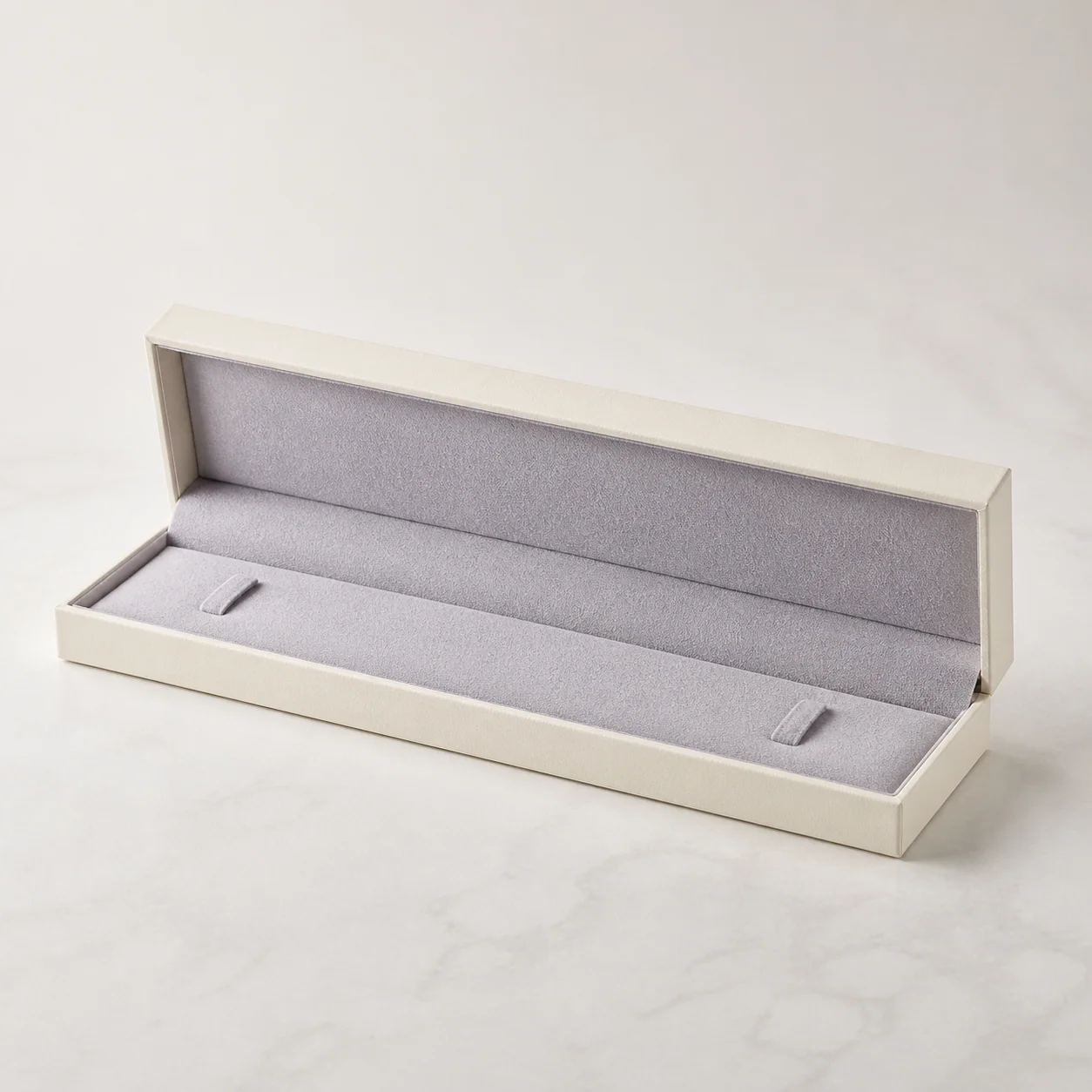 Ivory long jewelry presentation box with a gray-lavender insert
