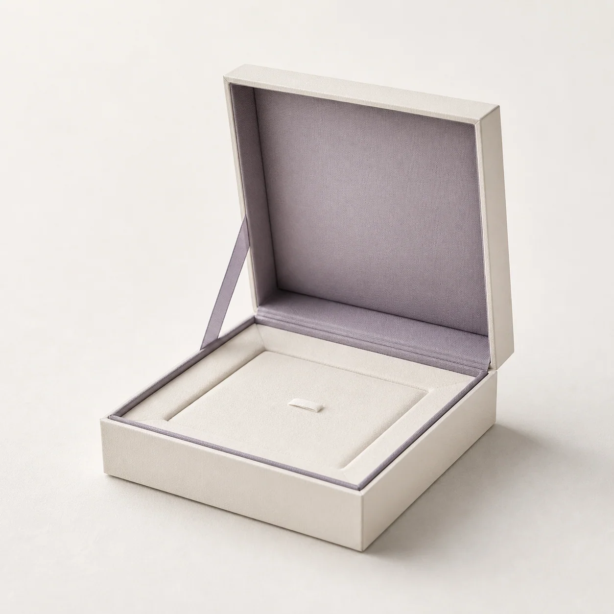 Ivory rigid paper jewelry box with a gray-lavender fitted insert