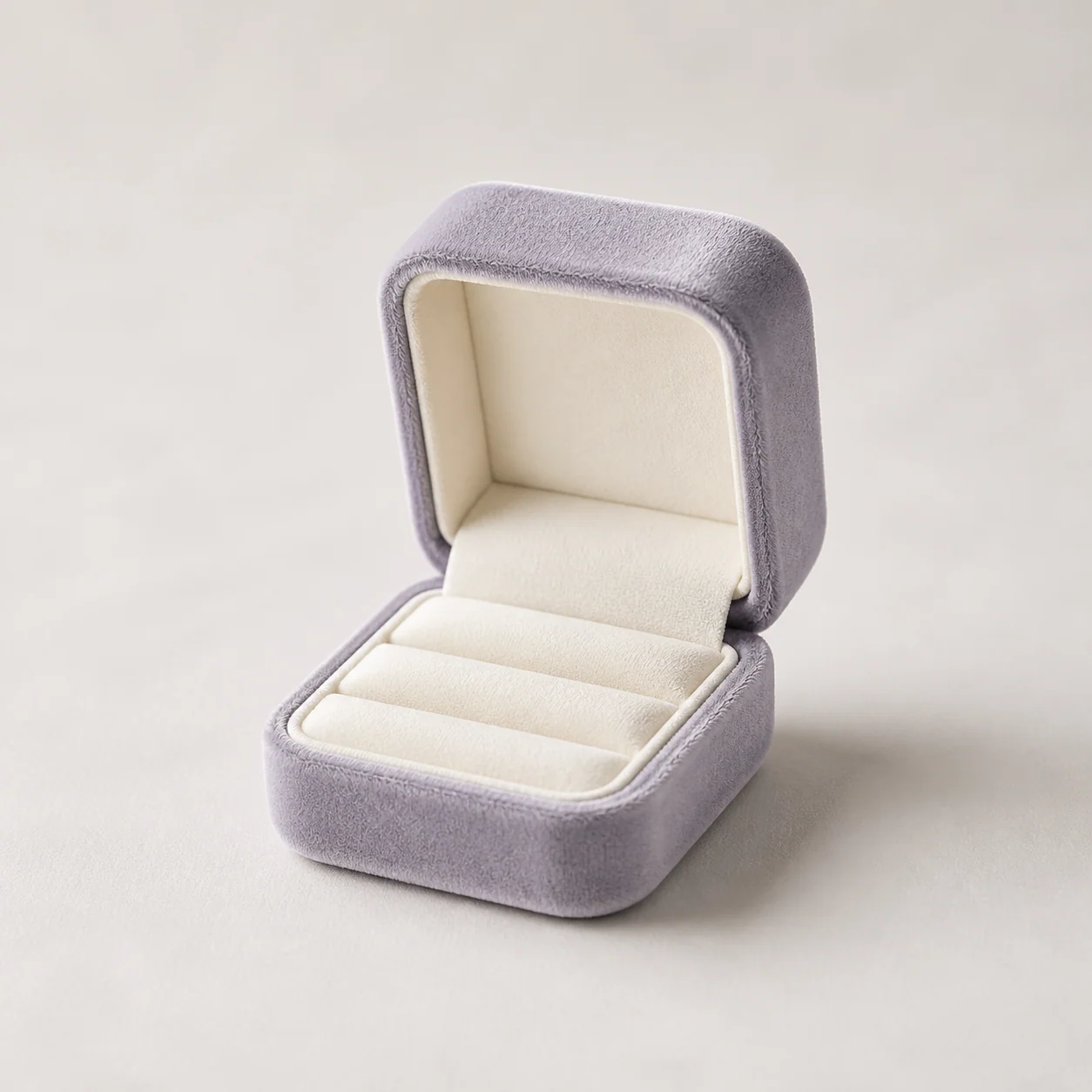 Gray-lavender velvet ring box with an ivory insert