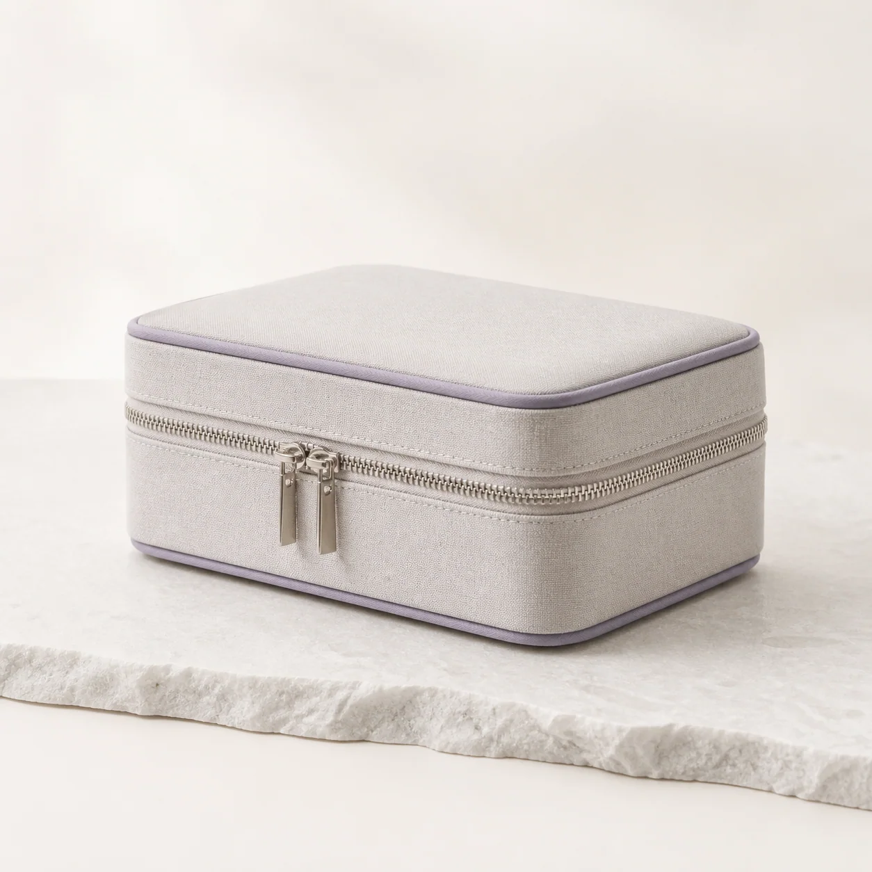 Light gray zip jewelry storage case with gray-lavender piping