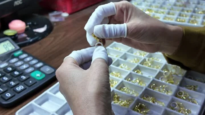 A NOVA team member checking the finished appearance of jewelry