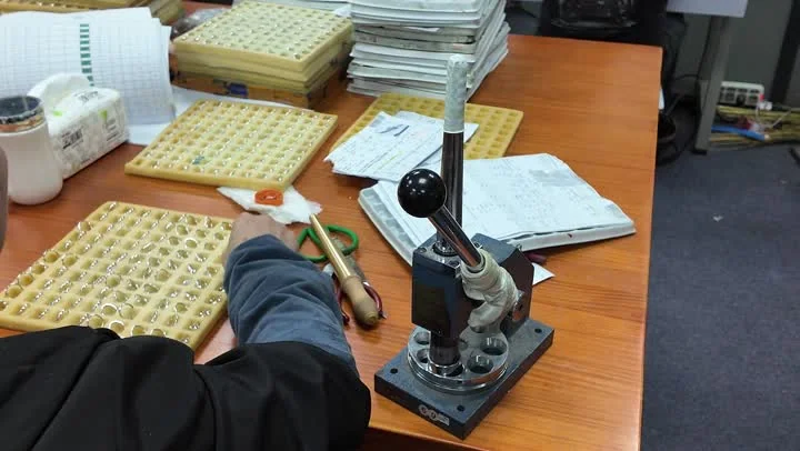 A jewelry component being checked with a workbench measurement tool